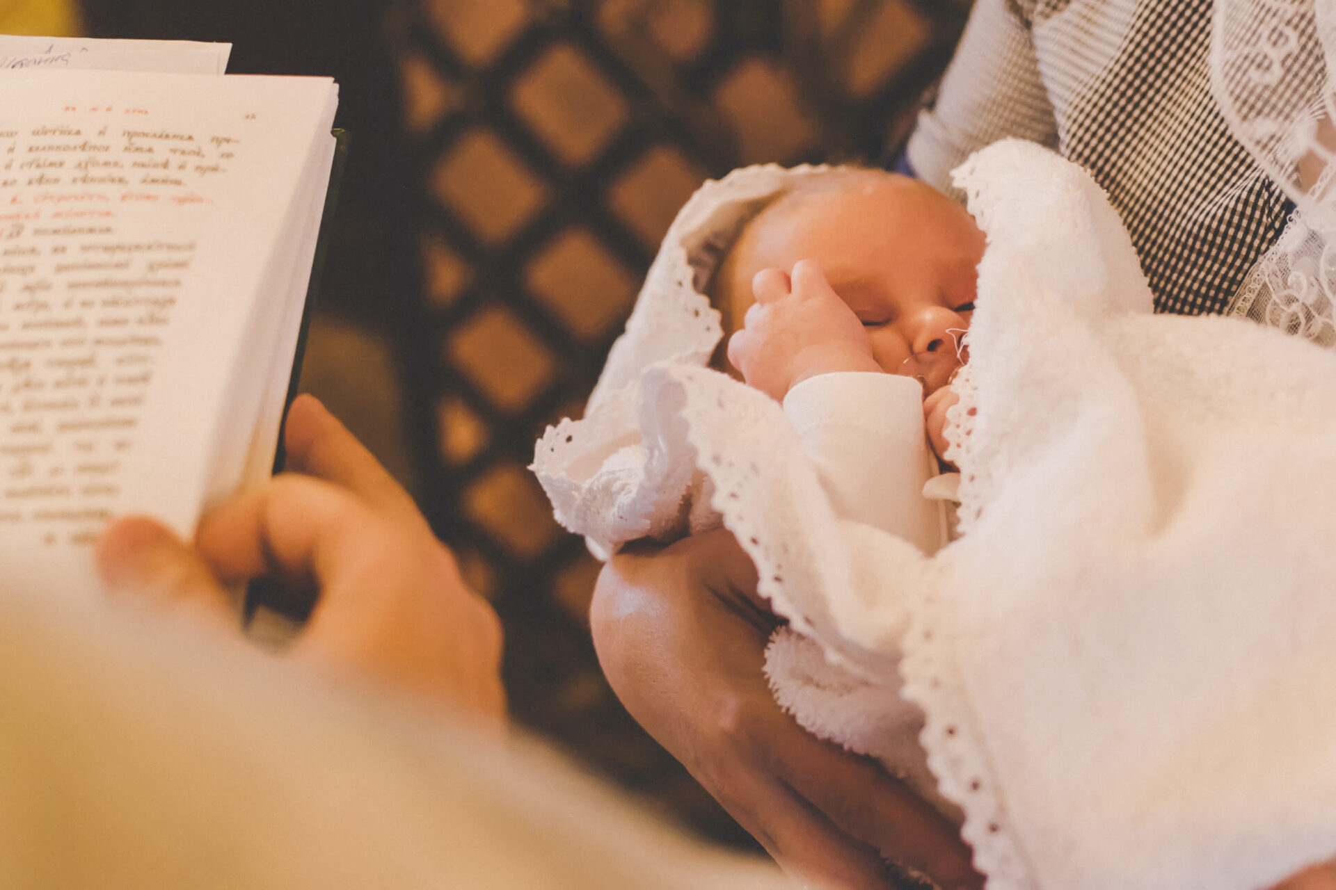 The sacrament of the baptism of a child. Selective focus. People.